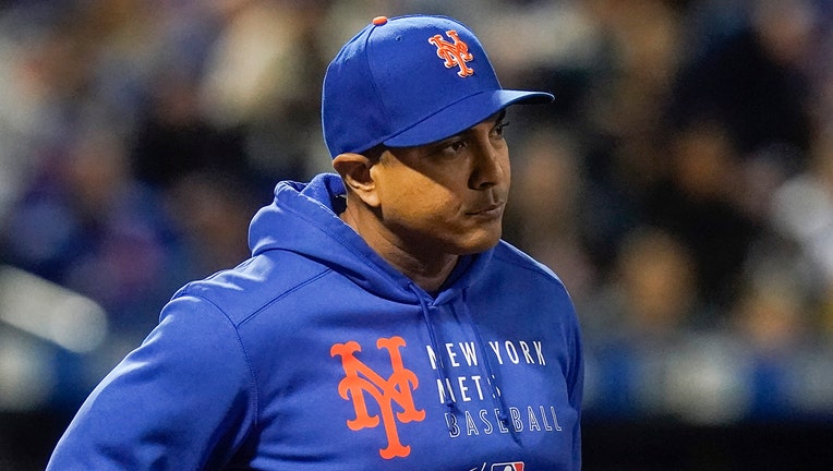 Luis Rojas wears a blue Mets cap and apparel