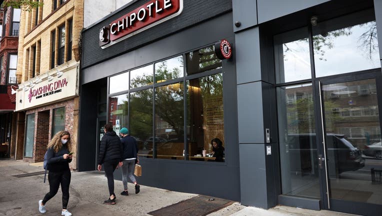 People walk past a Chipotle Mexican Grill in the Park Slope neighborhood on April 29, 2021 in the Brooklyn borough of New York City.
