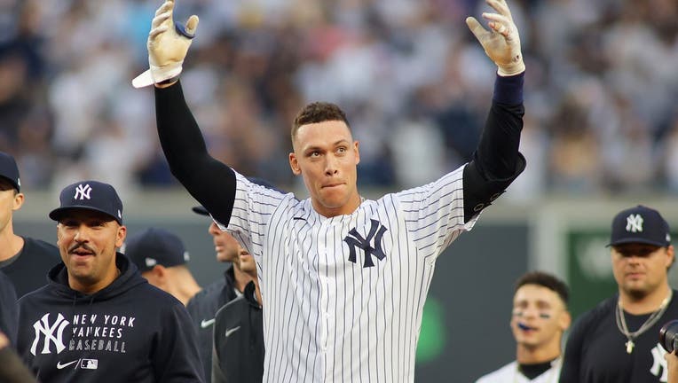 Aaron Judge #99 of the New York Yankees celebrates after hitting a walk-off single in the bottom of the ninth inning to beat the Tampa Bay Rays 1-0 at Yankee Stadium
