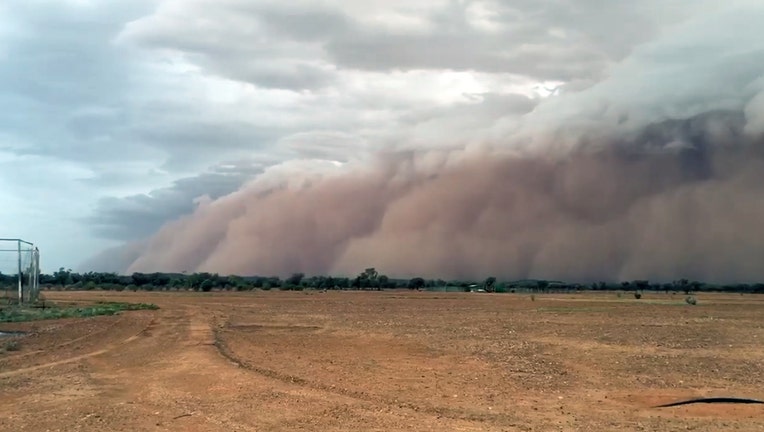 Dust cloud over arid dirt