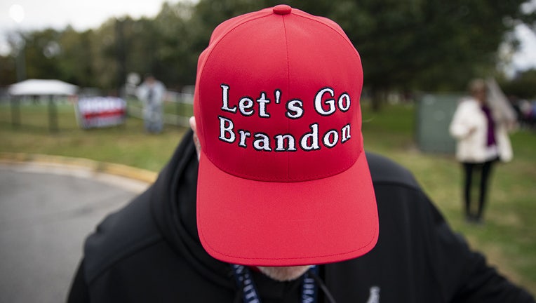 A supporter of former U.S. President Donald Trump displays a "Let's Go Brandon" hat before a campaign event for Terry McAuliffe, Democratic gubernatorial candidate for Virginia, in Arlington, Virginia, U.S., on Tuesday, Oct. 26, 2021.(Al Drago/Bloomberg via Getty Images)