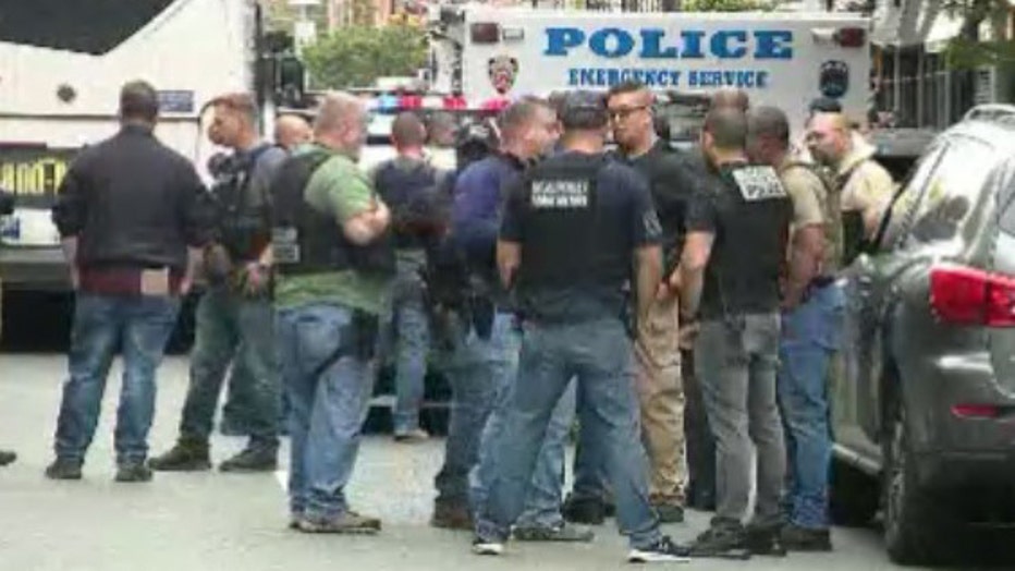 A man being served a warrant in Harlem shot at officers before turning the gun on himself, said police.