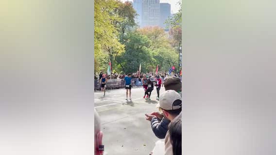 2 runners stop to help fellow runner over NYC Marathon finish line