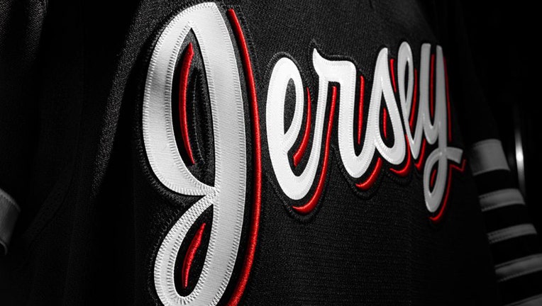 Jersey in white script with red outline on a black jersey