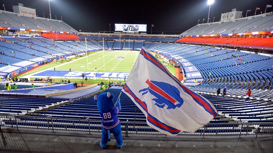 Buffalo Bills mascot waves a flag inside the stadium as fans leave