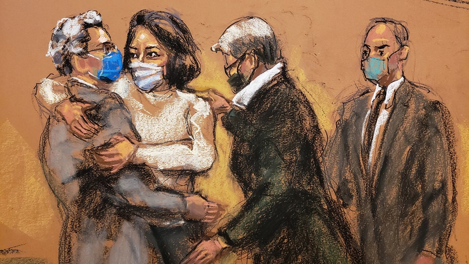 British socialite Ghislaine Maxwell hugs her attorney ahead of opening statements in her sex trafficking trial.