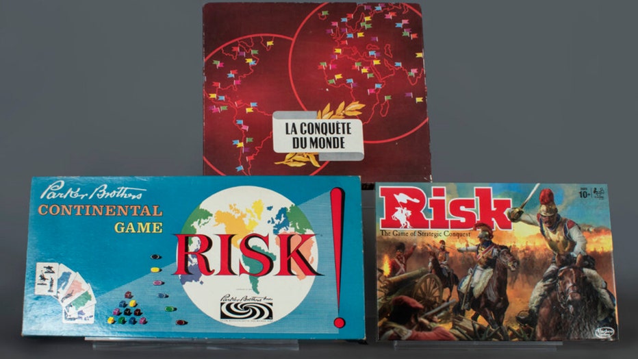 three board games in their boxes