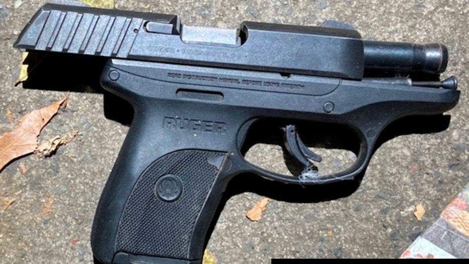 A black semiauto pistol with the slide racked back