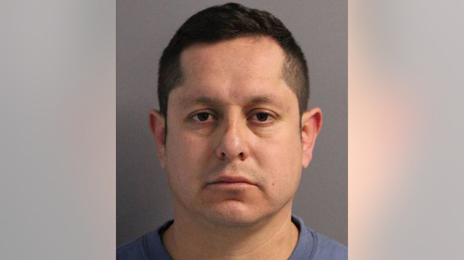 Mugshot of a man with dark hair and dark eyes