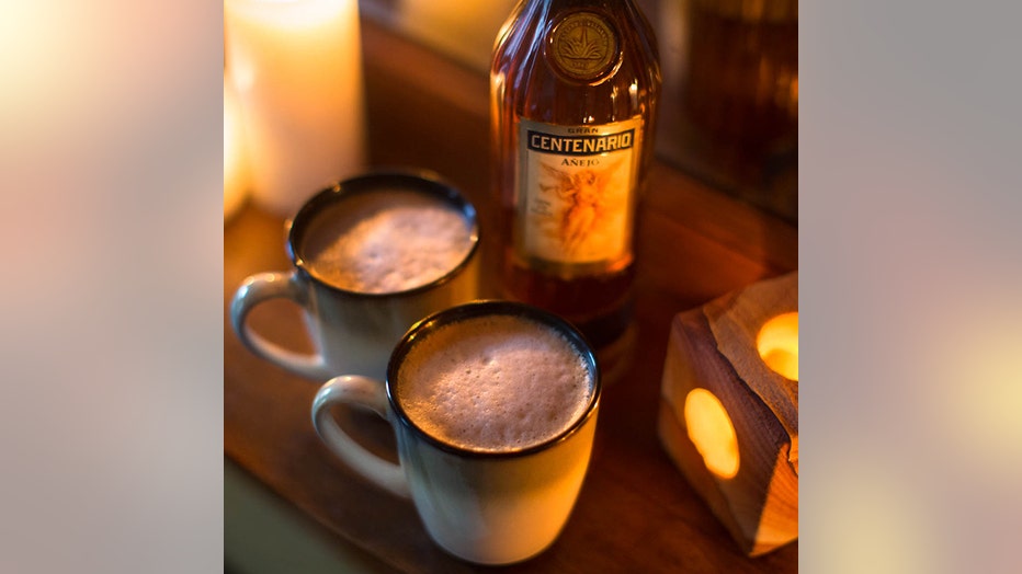 2 mugs of hot chocolate and a bottle of tequila