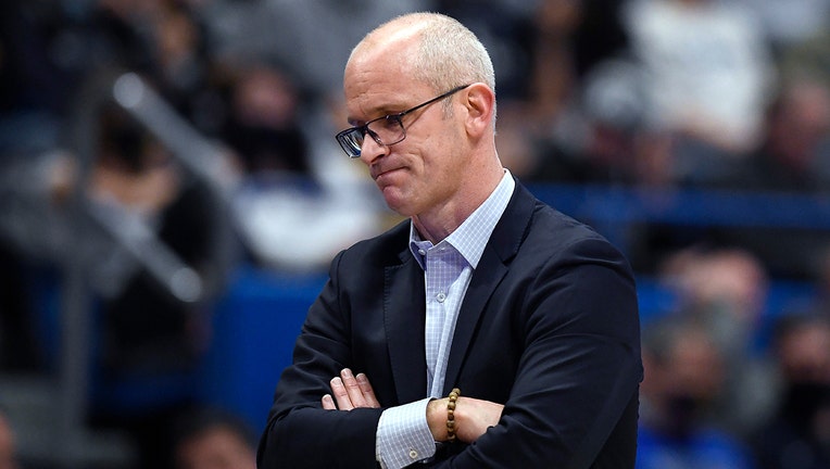 Dan Hurley with crossed arms, glasses think white hair