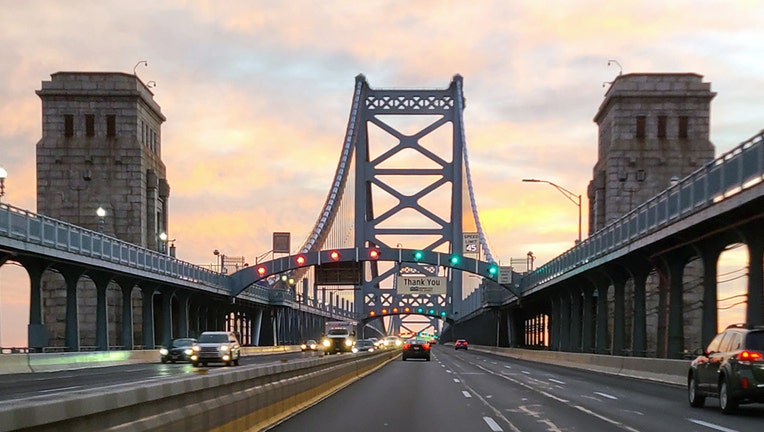 A POV image from a vehicle crossing the Benjamin Franklin Bridge