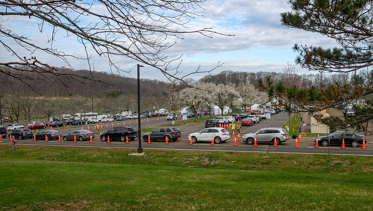 Cars line up in a parking lot for covid testing