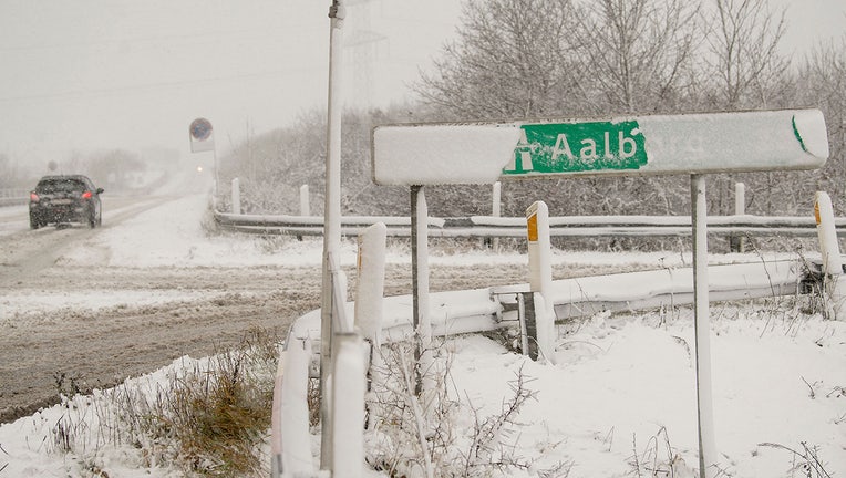 A road sign for Aalborg is covered with snow during snow fall along the Motorway E45 near Stoevring, Northern Jutland, Denmark on December 1, 2021.(Photo by BO AMSTRUP/Ritzau Scanpix/AFP via Getty Images)