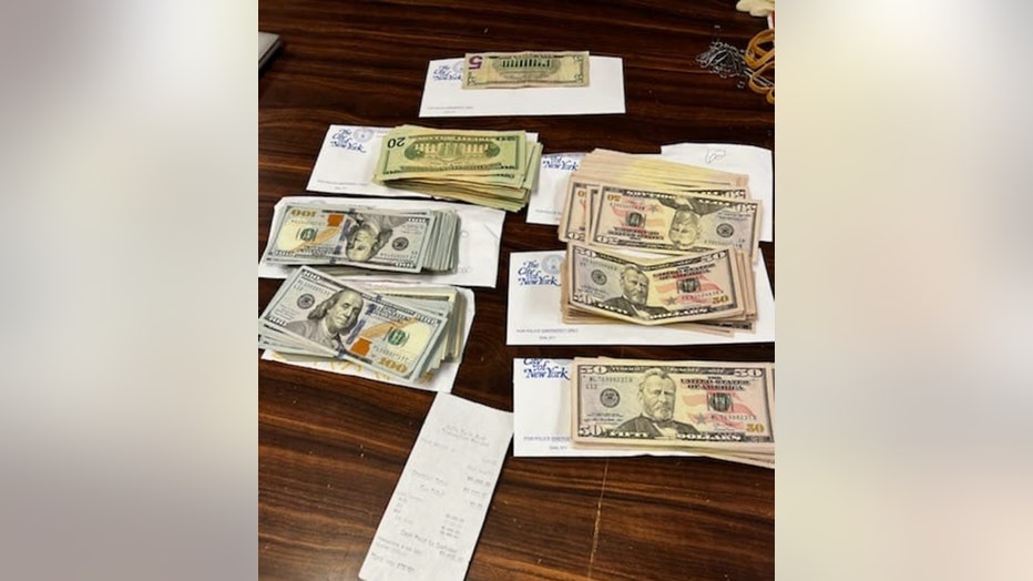Piles of U.S. currency on white envelopes