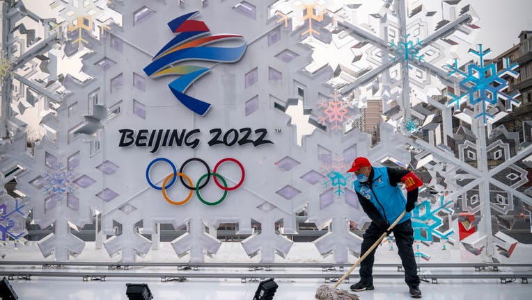 A volunteer cleans a sculpture about Beijing 2022 Winter Olympics on January 23, 2022 in Beijing, China. (Photo by Andrea Verdelli/Getty Images)
