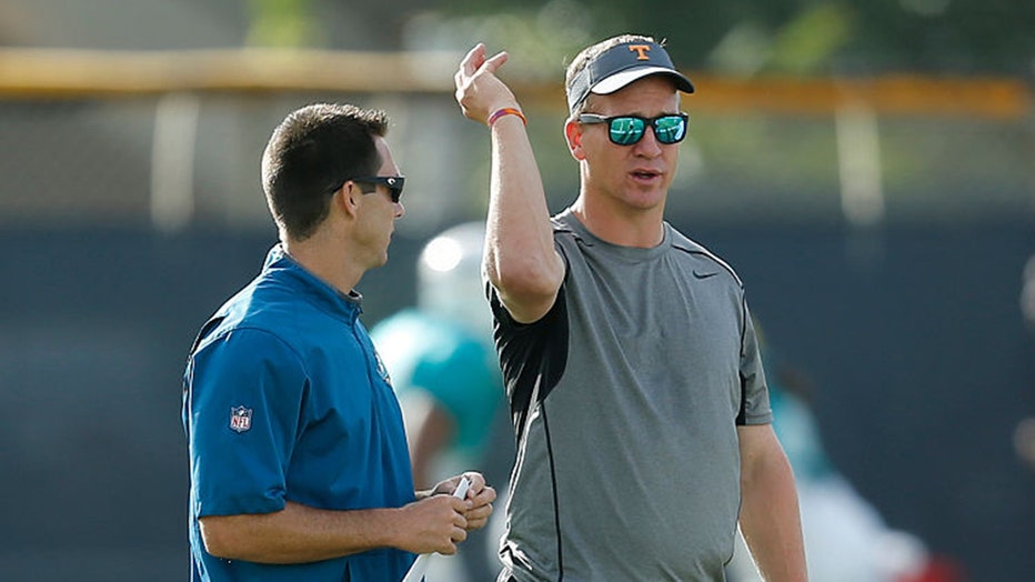 DAVIE, FL - AUGUST 1: (L - R) Joe Schoen, Director of Player Personnel and Peyton Manning, for NFL quarterback watches the Miami Dolphins run drills during the teams training camp on August 1, 2016 at the Miami Dolphins training facility in Davie, Florida. (Photo by Joel Auerbach/Getty Images)