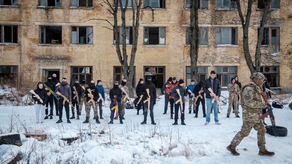 Participants learn how to handle a firearm during an introductory level military and first aid training for civilians by the Azov regiment of the National Guard of Ukraine at their base in Kyiv, Ukraine, on Sunday, Jan. 30, 2022. 