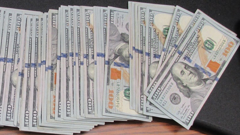 Some of the cash recovered by the Suffolk County Police Department is displayed in a handout photo.