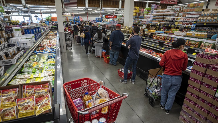 Customers stand in line to check out at a grocery store in San Francisco, California, U.S., on Thursday, Nov. 11, 2021.(David Paul Morris/Bloomberg via Getty Images)