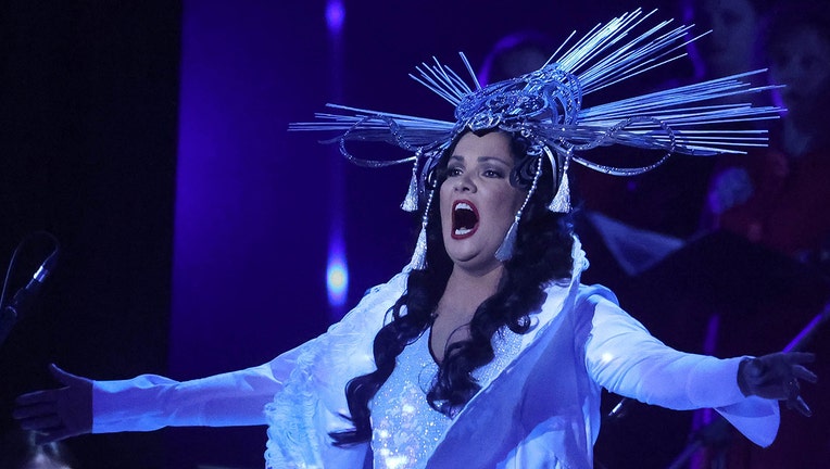 Opera singer in while gown and headgear