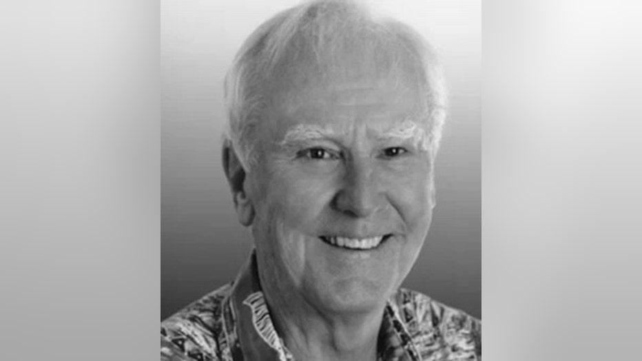 Black-and-white headshot portrait of a man with white hair