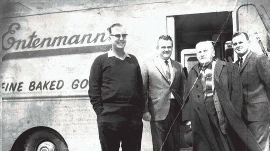 Four men stand in front of a bakery delivery van labeled "Entenmann's"