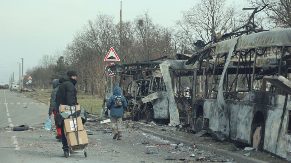 FILE - A view of damaged buildings and vehicles after shelling in the Ukrainian city of Mariupol under the control of Russian military and pro-Russian separatists, on March 29, 2022. (Photo by Leon Klein/Anadolu Agency via Getty Images)