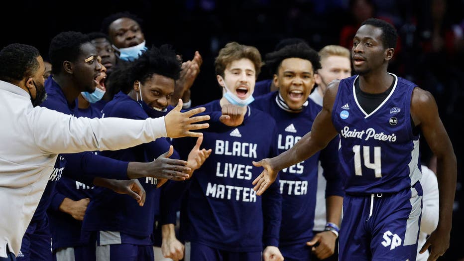 Hassan Drame #14 of the St. Peter's Peacocks reacts with teammates on the sidelines in the first half of the game against the Purdue Boilermakers in the Sweet Sixteen round of the 2022 NCAA Men's Basketball Tournament at Wells Fargo Center on March 25, 2022 in Philadelphia, Pennsylvania. (Photo by Tim Nwachukwu/Getty Images)