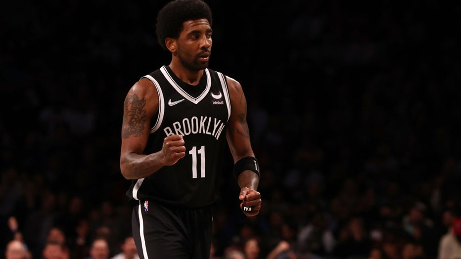 NEW YORK, NEW YORK - MARCH 27: Kyrie Irving #11 of the Brooklyn Nets pumps his fist against the Charlotte Hornets at Barclays Center on March 27, 2022 in New York City.