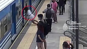 Video:  Woman falls under moving train and survives