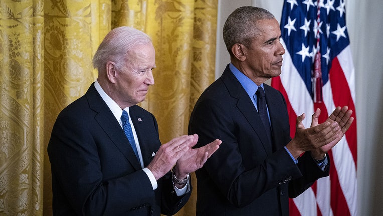 Former U.S. President Barack Obama, right, and U.S. President Joe Biden applaud during an event in the East Room of the White House in Washington, D.C., U.S., on Tuesday, April 5, 2022. (Photographer: Al Drago/Bloomberg via Getty Images)