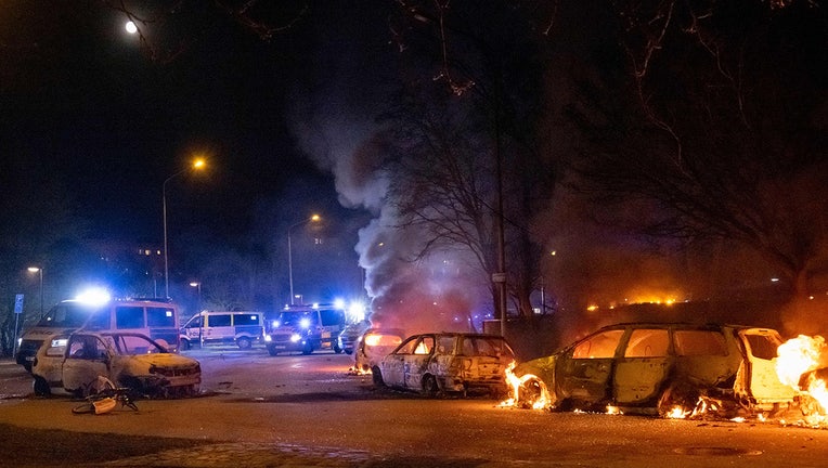 Burning cars are pictured on April 18, 2022 near Rosengard in Malmo. Plans by a far-right group to publicly burn copies of the Koran sparked violent clashes with counter-demonstrators for the third day running in Sweden, police said.(Photo by JOHAN NILSSON/TT NEWS AGENCY/AFP via Getty Images)