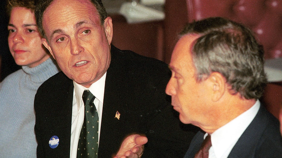 FILE: New York City Mayor Rudolph Giuliani and New York City Republican mayoral candidate Michael Bloomberg eat lunch November 5, 2001 at Forlini's Italian restaurant during a campaign stop in Manhattan. (Photo by Shaul Schwarz/Getty Images)