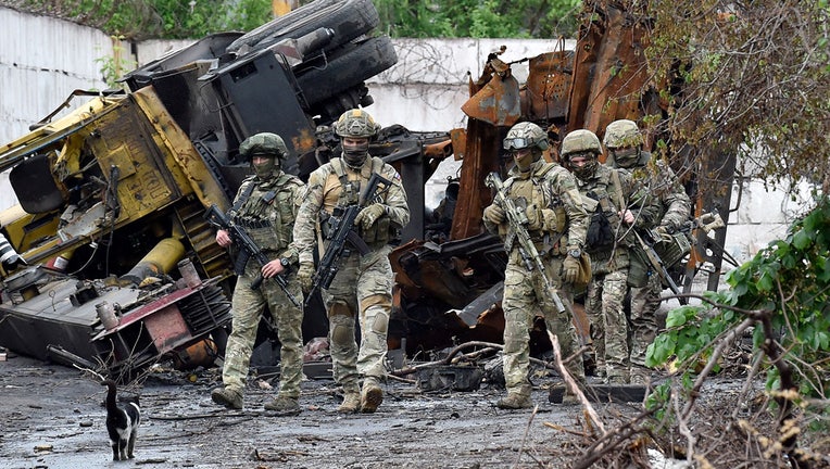 Russian servicemen patrol the destroyed part of the Ilyich Iron and Steel Works in Ukraine's port city of Mariupol on May 18, 2022, amid the ongoing Russian military action in Ukraine. (Photo by Olga MALTSEVA / AFP) (Photo by OLGA MALTSEVA/AFP via Getty Images)