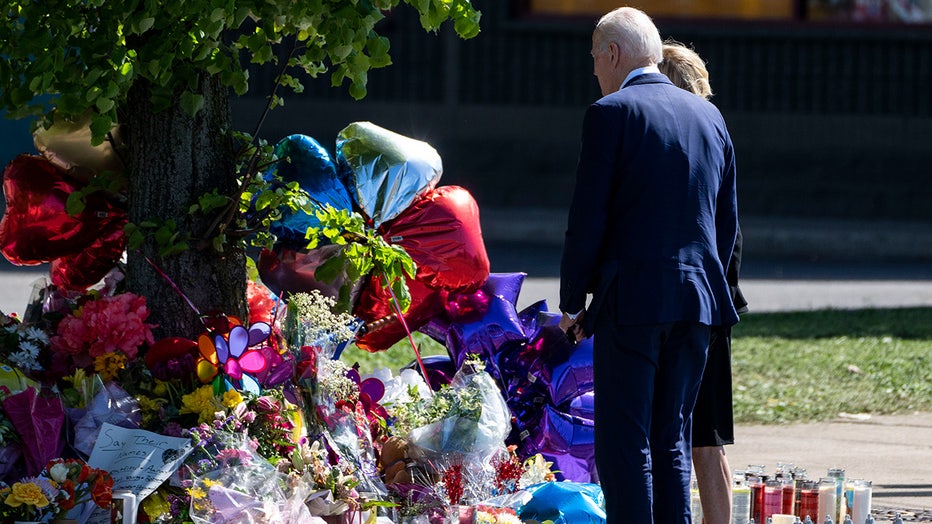 President Joe Biden stands with First Lady Dr. Jill Biden places flowers at a memorial just across the street of the Tops Friendly Market at Jefferson Avenue and Riley Street on Tuesday, May 17, 2022 in Buffalo, NY. (Kent Nishimura / Los Angeles Times via Getty Images)