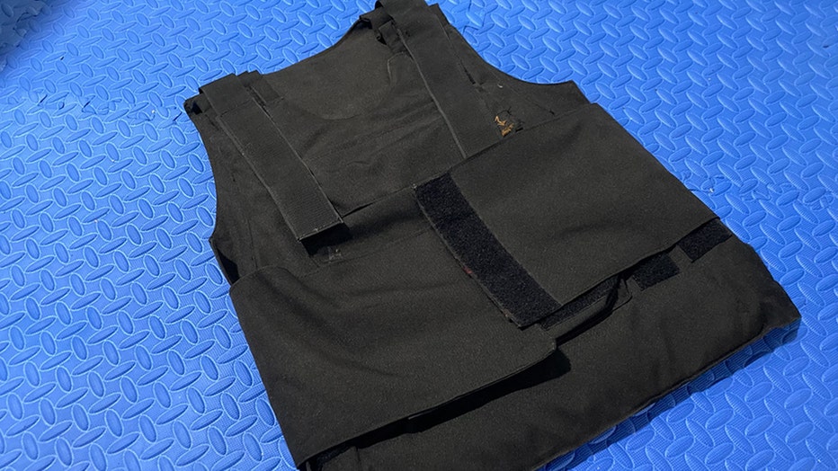 Black bulletproof vest on a blue background