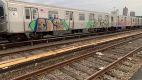 Man, woman arrested for spray-painting graffiti on subway cars in Queens: NYPD