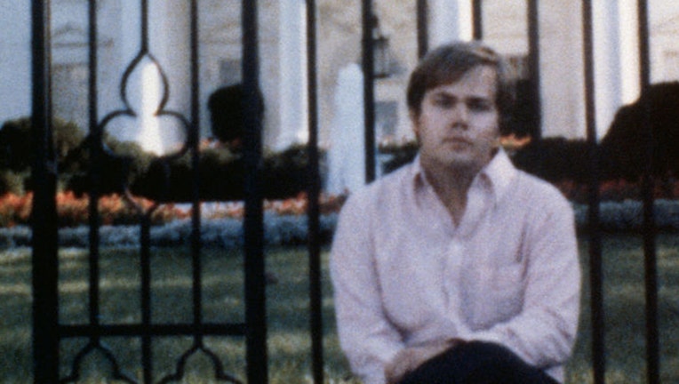4/1/81-Washington, DC-ORIGNAL CAPTION READS: This photo aquired by UPI shows John Hinckley Jr., as he sits on fence wall in front of the White House. Hinckley is accused as the attempted assasin of President Ronald Regan. The picture is undated, but believed to have been taken within the past year.