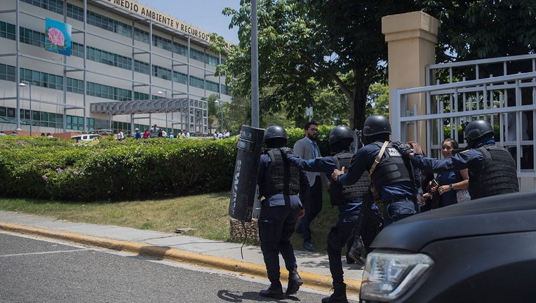Police are deployed at the Dominican Ministry of Environment headquarters during a shooting, in Santo Domingo, on June 6, 2022. (Photo by ERIKA SANTELICES/afp/AFP via Getty Images)