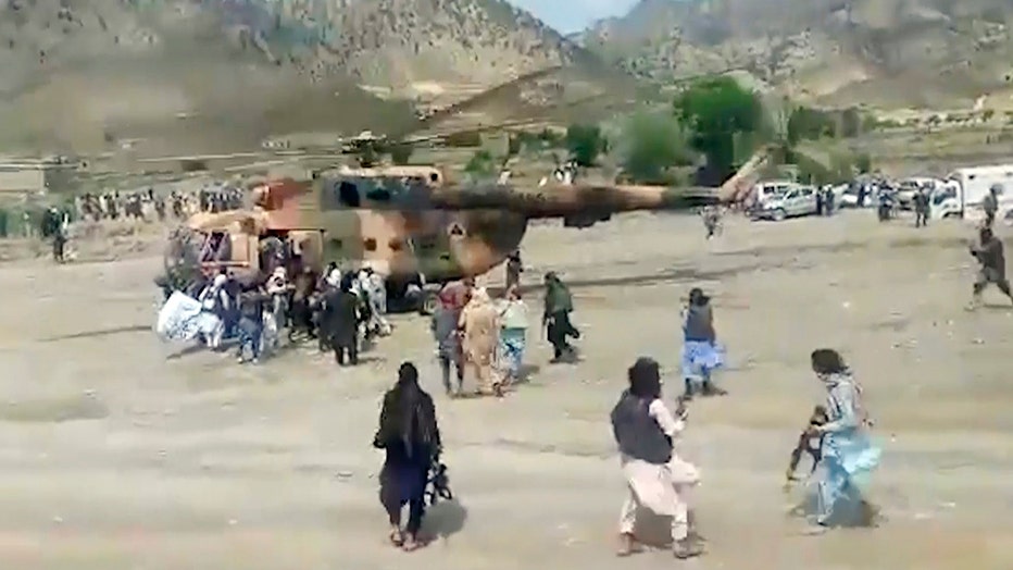 In this image taken from video from Bakhtar State News Agency, Taliban fighters secure a government helicopter to evacuate injured people in Gayan district, Paktika province, Afghanistan, Wednesday, June 22, 2022.