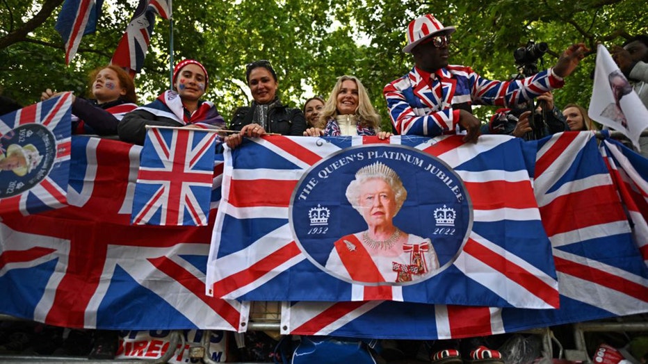 TOPSHOT - Royal fans line the Mall as they wait for the trooping of the colour as part of Queen Elizabeth II's platinum jubilee celebrations, on June 2, 2022, in London.