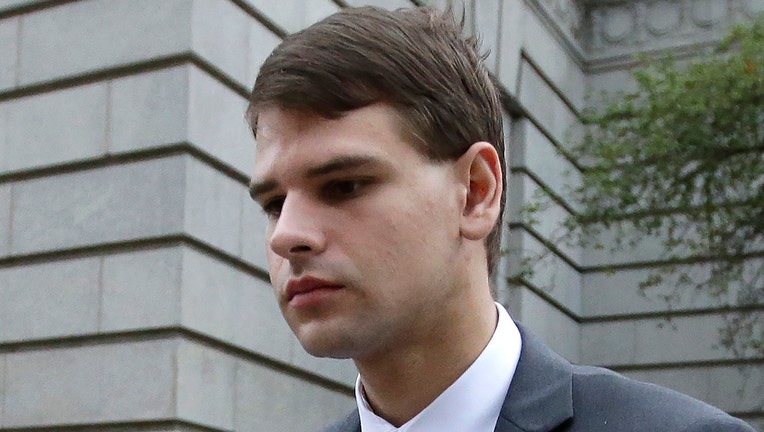 FILE - In this Aug. 21, 2019, file photo, Nathan Carman departs federal court in Providence, R.I. Carman, charged with killing his mother at sea in a plot to inherit millions of dollars, asked a federal court Wednesday, July 6, 2022, to authorize his release from custody pending trial.