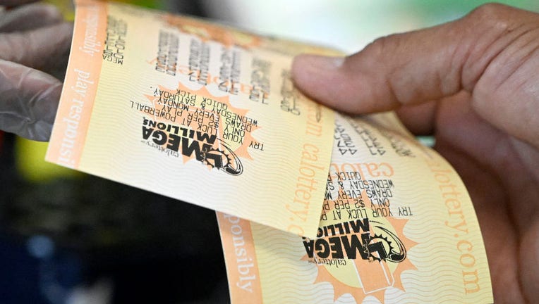 FILE - A customer's Mega Millions come out of the lottery printing machine at a 7-Eleven. (Photo by Will Lester/MediaNews Group/Inland Valley Daily Bulletin via Getty Images)