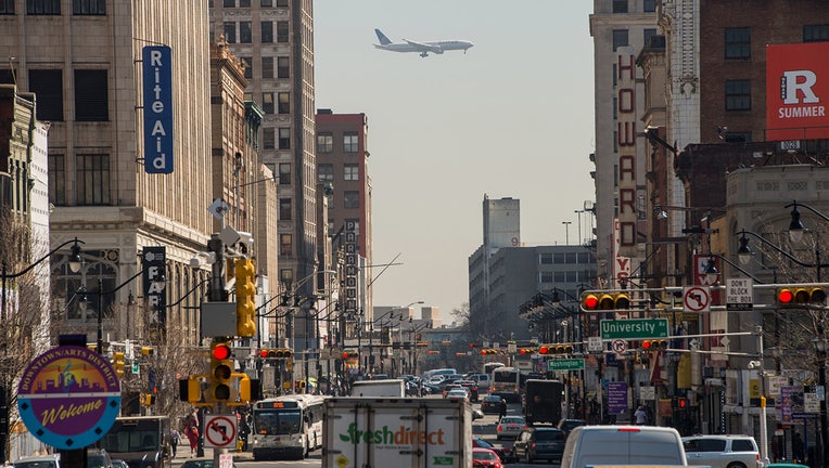 A plane is seen flying over Market Street heading towards Newark International Airport in Newark, New Jersey, (Ron Antonelli/Bloomberg via Getty Images)