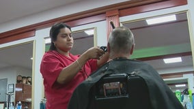 Women training to become barbers