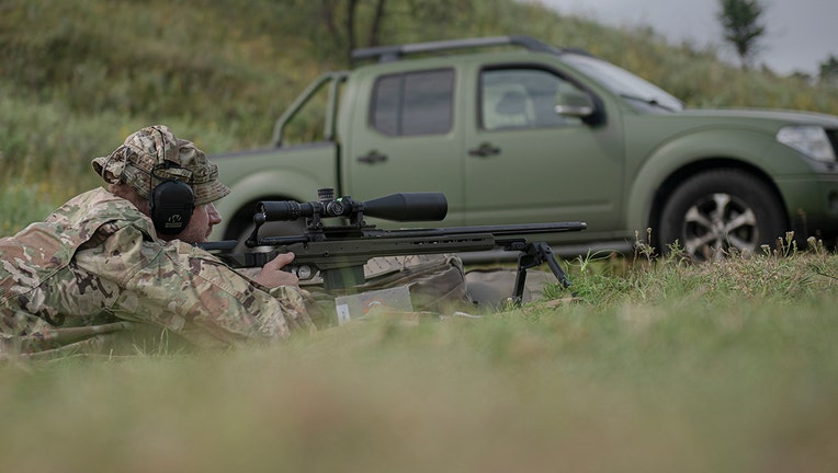 Ukrainian sniper Andriy attends a training outside of Kyiv, Ukraine, Saturday, Aug. 27, 2022. (AP Photo/Andrew Kravchenko)