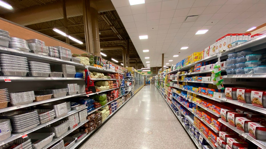 Food packaging aisle with tins for cooking and plastic storage options, Publix grocery store, Florida