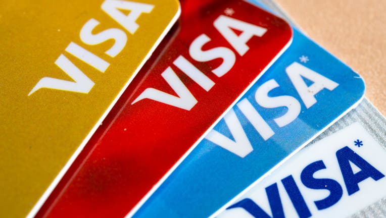 In this photo illustration there are four Visa credit cards