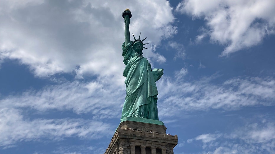 Statue of Liberty seen on a bright day with clouds